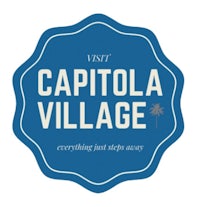 a blue and white logo with the words capitola village